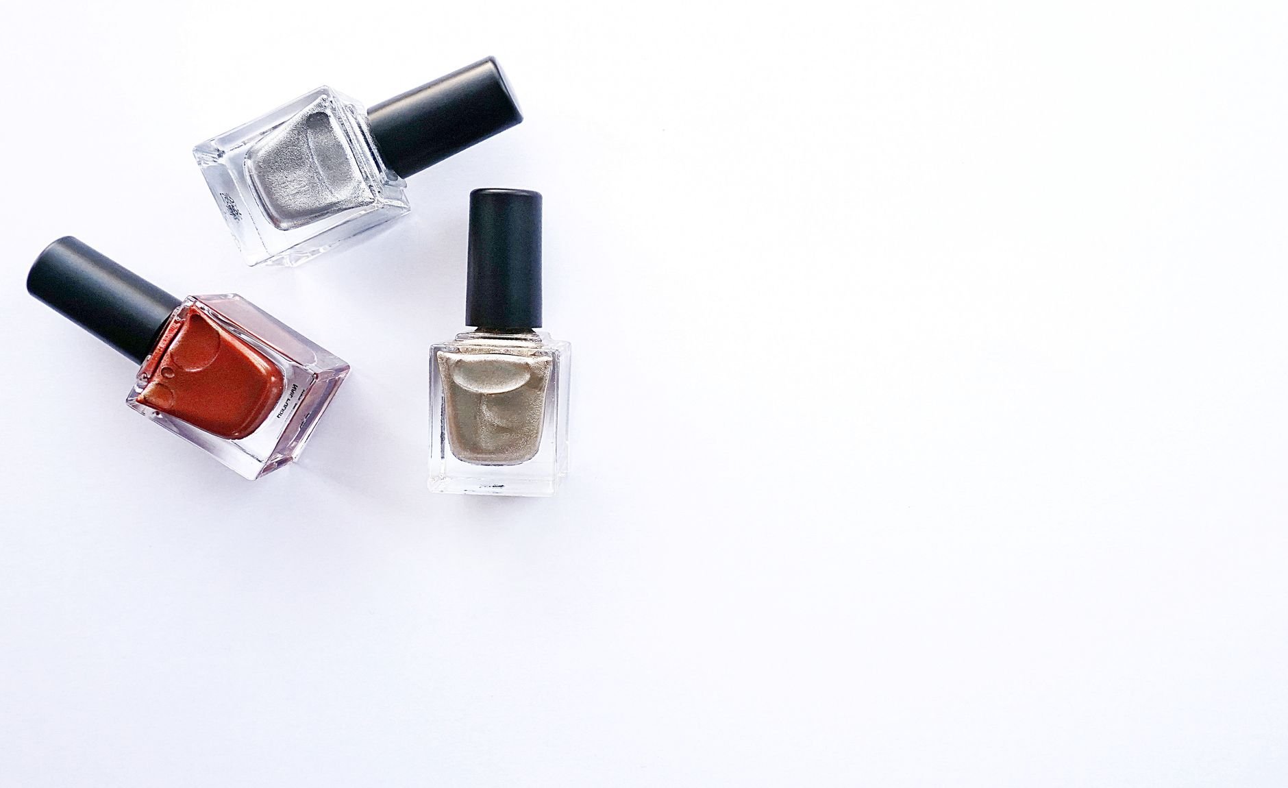 Three Lacé nail polish bottles arranged elegantly showing the warm nude shade collection